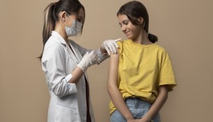 medium-shot-smiley-girl-getting-vaccinated