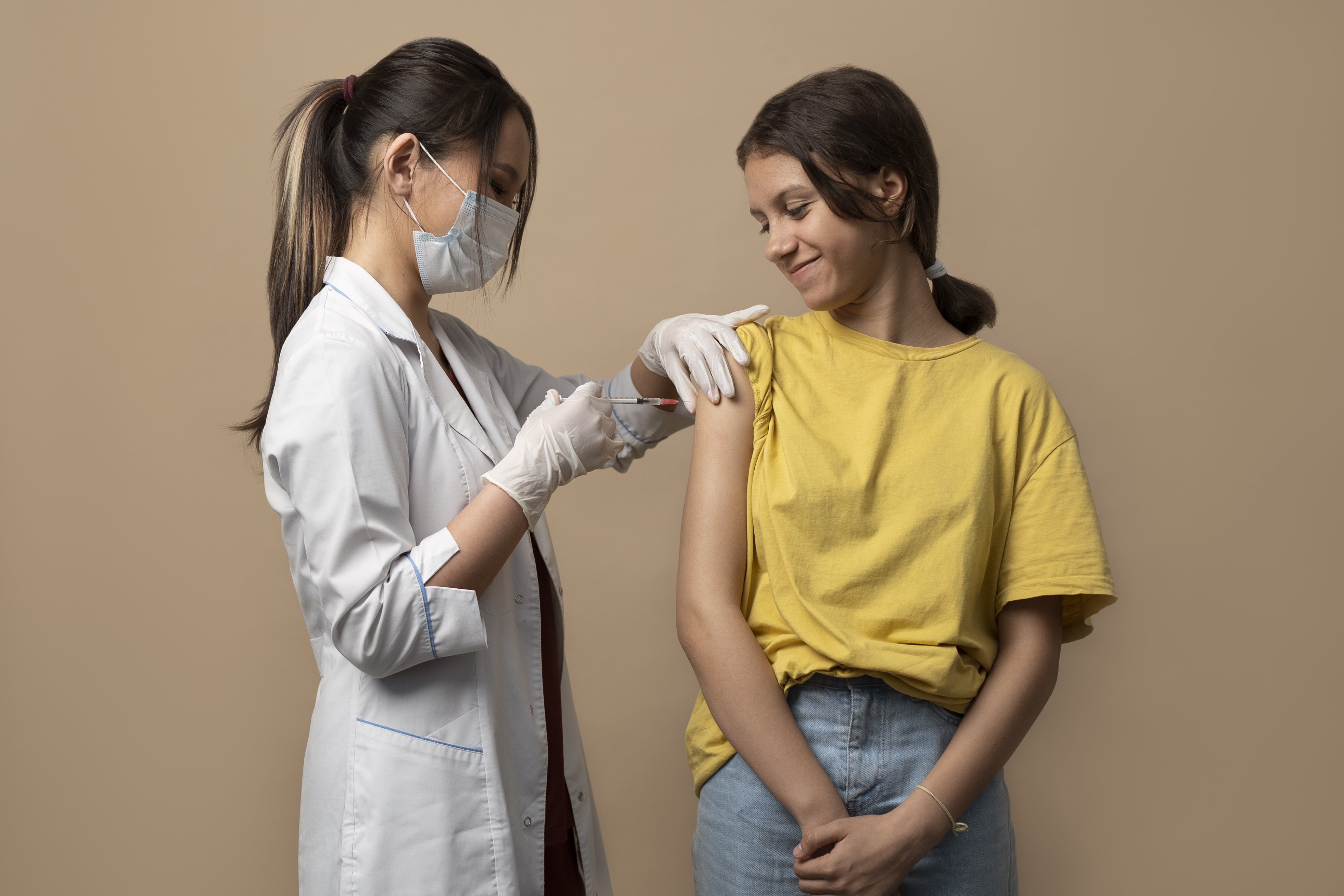 medium-shot-smiley-girl-getting-vaccinated