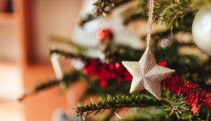 Selective focus shot of star ornament hanging on Christmas tree
