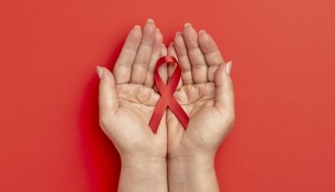 person-holding-world-aids-day-ribbon