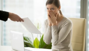 Employer giving dismissal notice to young woman