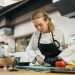 female-chef-chopping-vegetables-kitchen