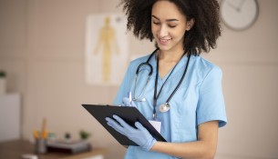 female-doctor-taking-notes-clipboard