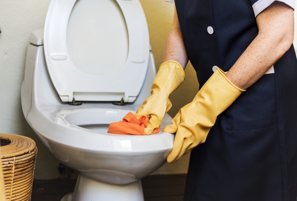 housekeeper-cleaning-hotel-room