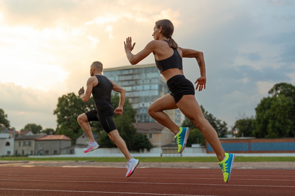 man-woman-running-track-side-view