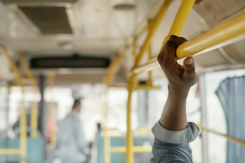 close-up-hand-holding-bus-bar