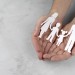 close-up-hands-holding-paper-family