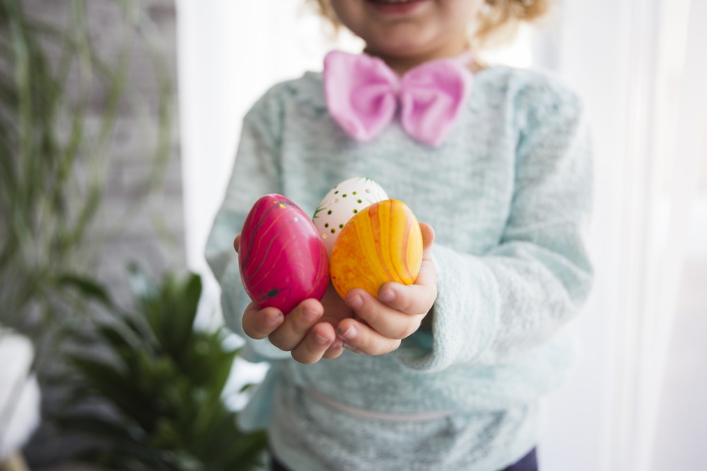 crop-girl-showing-easter-eggs