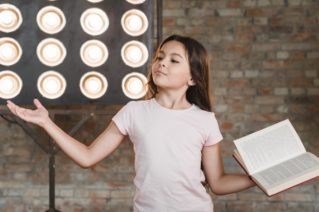 girl-standing-front-stage-light-performing