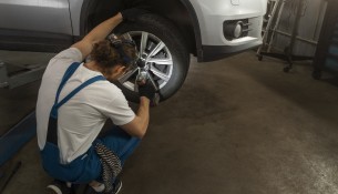 male-mechanic-working-shop-car