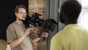man-filming-with-professional-camera