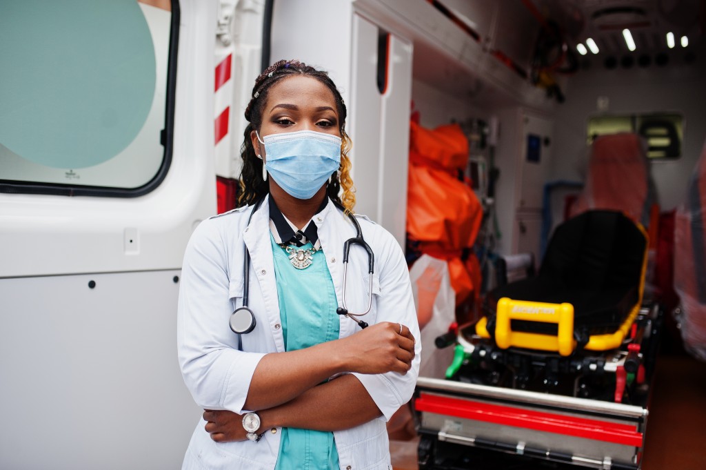 African american female paramedic in face protective medical mas