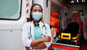 African american female paramedic in face protective medical mas