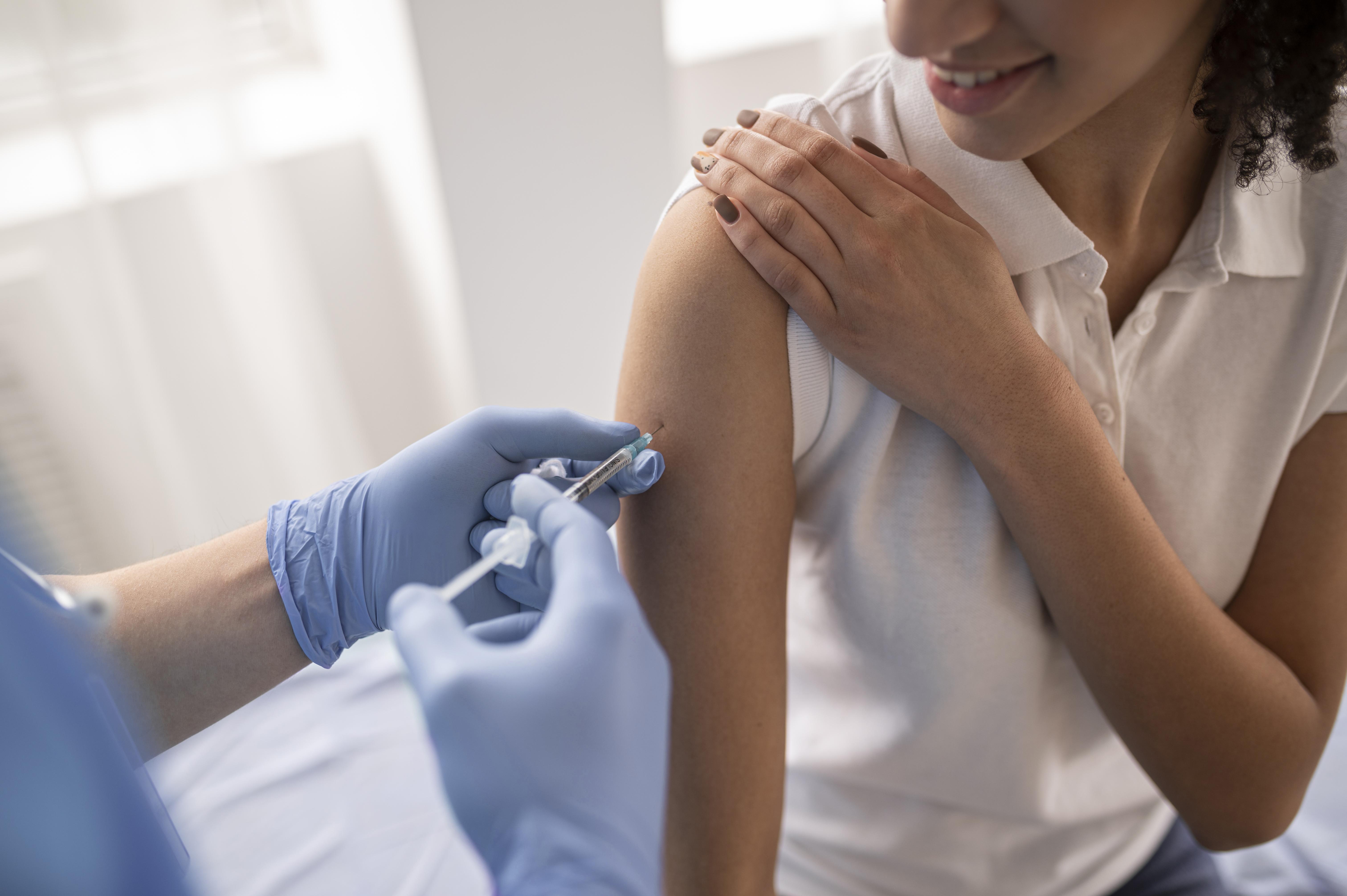 doctor-vaccinating-patient-clinic