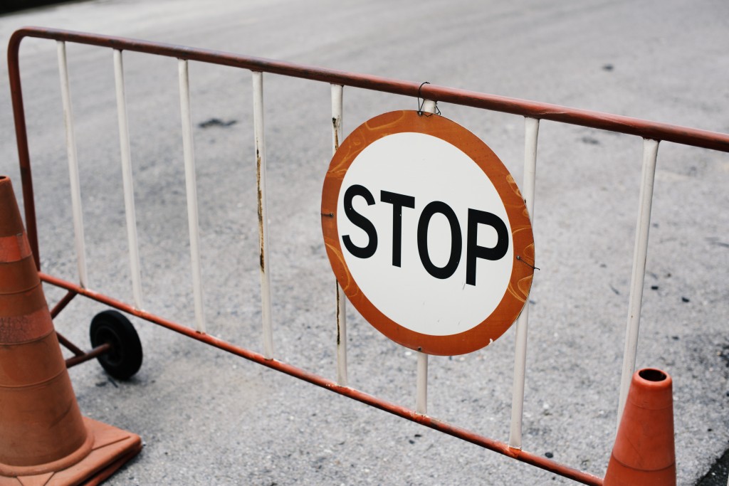 Mobile steel barrier fence with stop sign