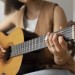 young-woman-playing-guitar-indoors