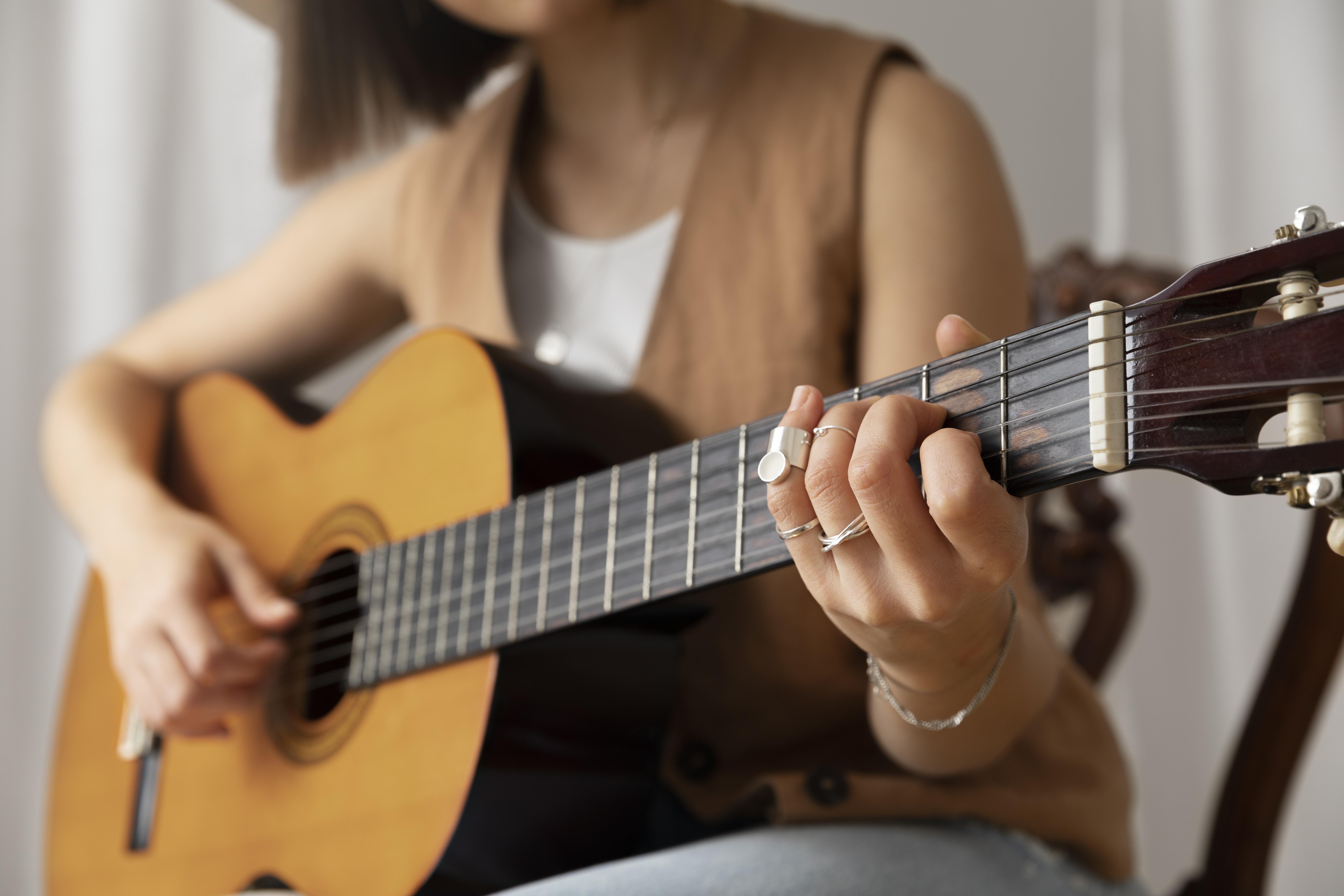 young-woman-playing-guitar-indoors