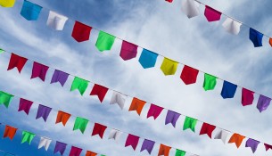 Small cute colorful flags on rope hanging outside for holiday wi