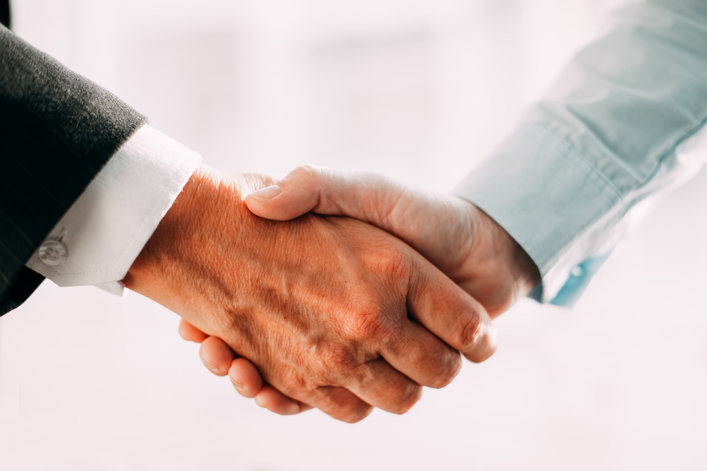 Close-up of business partners shaking hands