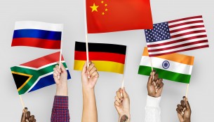 Hands waving flags of China, Germany, India, South Africa, and Russia