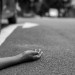 Person lying on the ground after a car accident