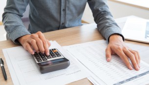 Accountant calculating income and examining report