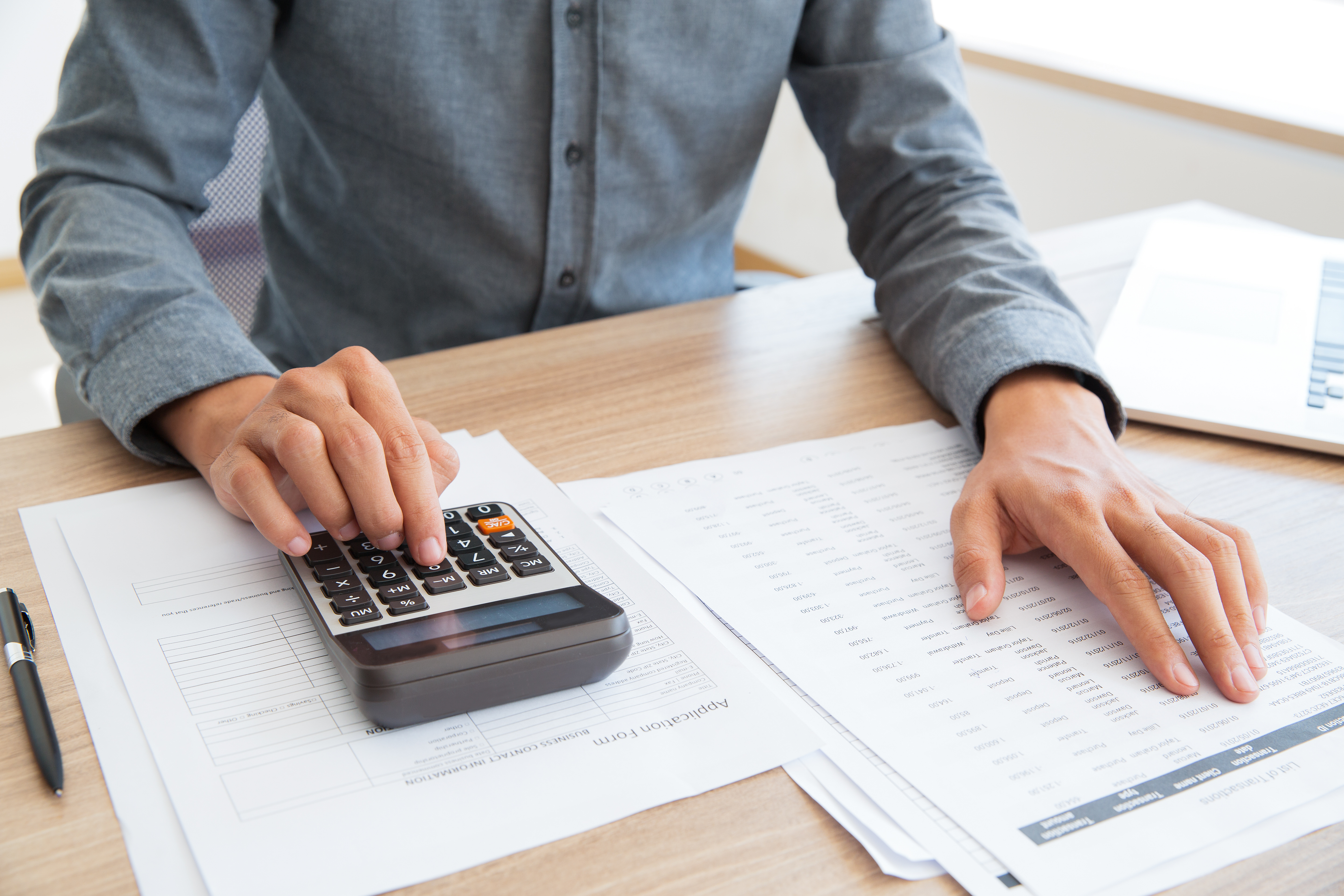 Accountant calculating income and examining report