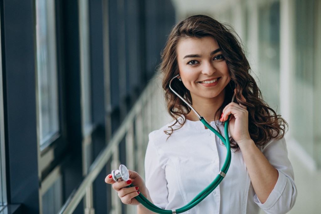 Young woman doctor with stethoscope at hospital