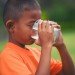 Little boy drinking milk in the park