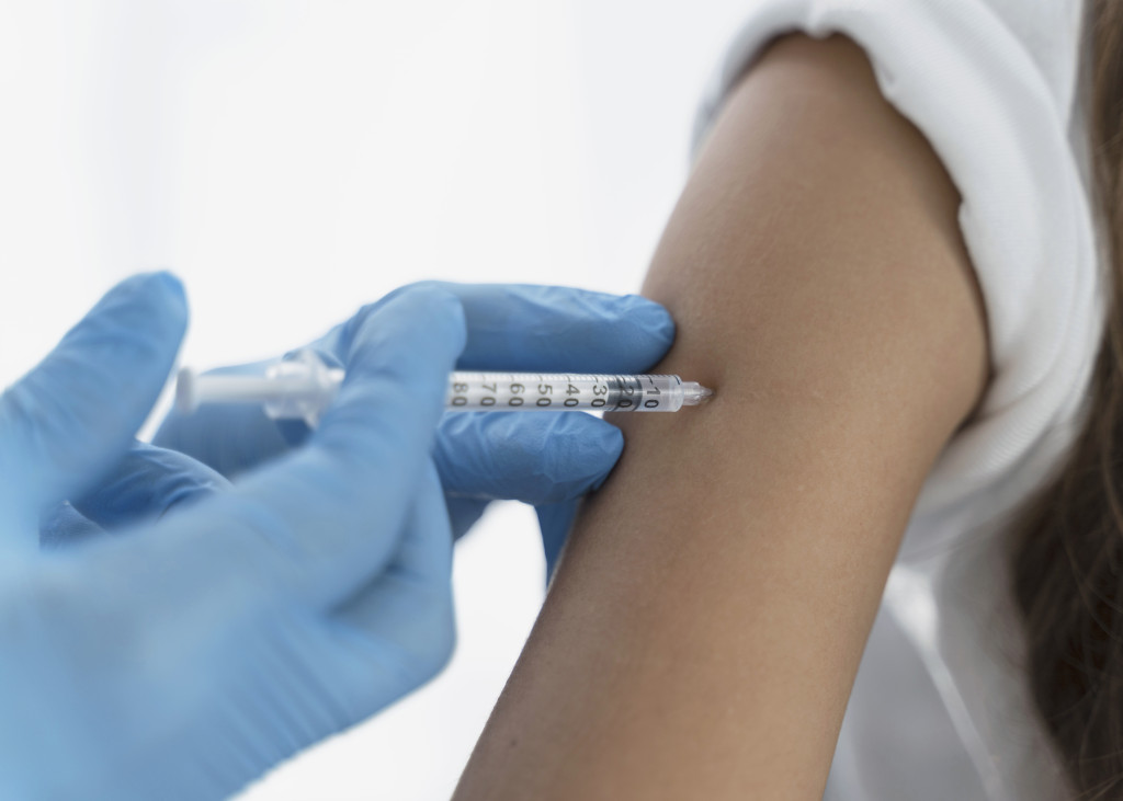 close-up-doctor-vaccinating-little-girl