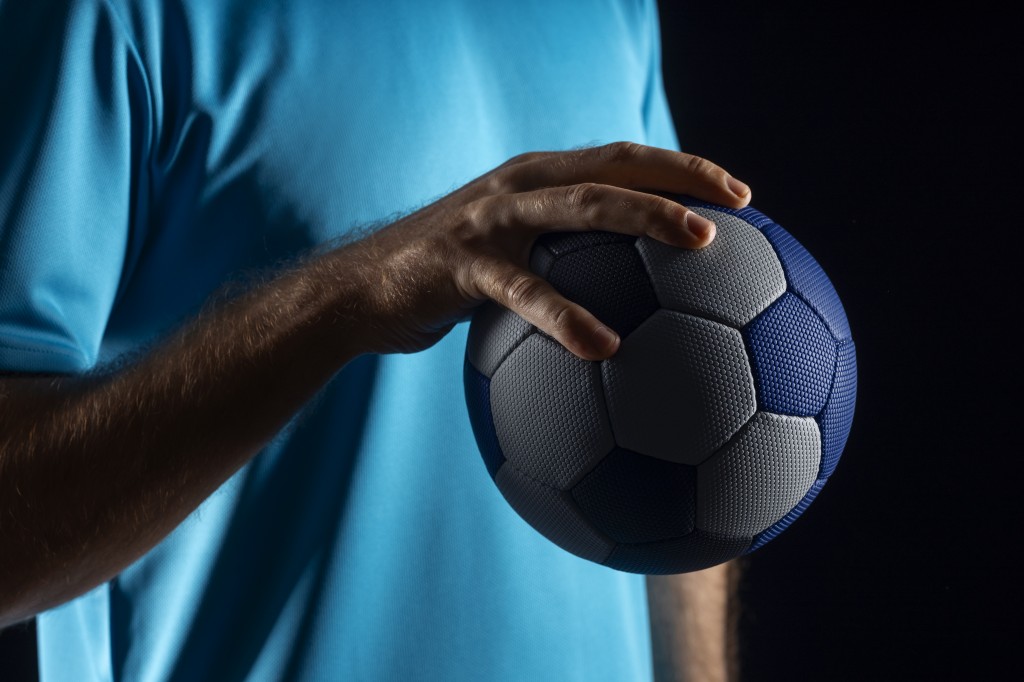 close-up-hand-holding-handball-ball