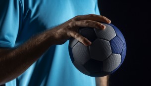 close-up-hand-holding-handball-ball