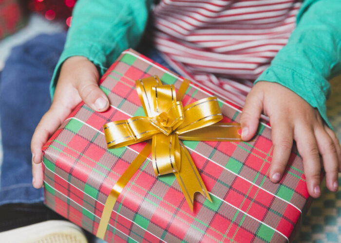 christmas-concept-with-kid-gift-box-scaled-700x500