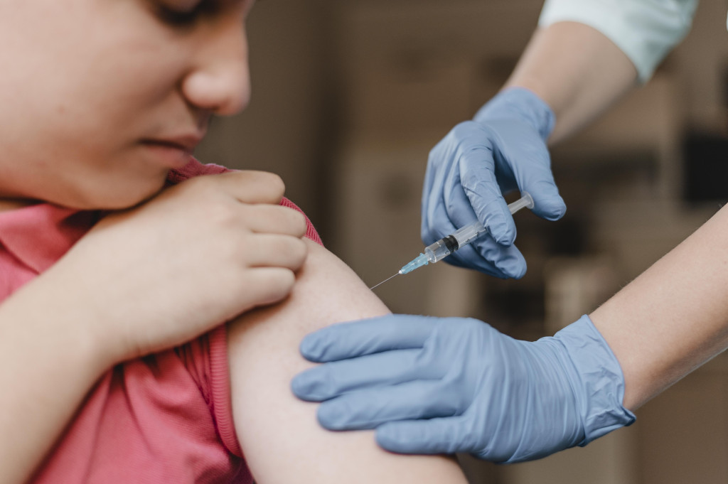 doctor-wearing-gloves-giving-kid-vaccine