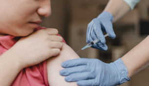 doctor-wearing-gloves-giving-kid-vaccine