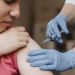 doctor-wearing-gloves-giving-kid-vaccine