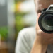 Reflection in the mirror of a man with a camera copy space.