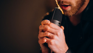 Singer with microphone singing in studio