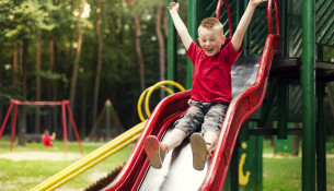 Active boy sliding down