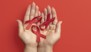 person-holding-world-aids-day-ribbon-symbol