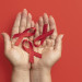 person-holding-world-aids-day-ribbon-symbol