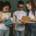 school-colleagues-looking-through-books-together