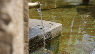 water-running-into-old-fountain-from