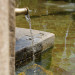 water-running-into-old-fountain-from